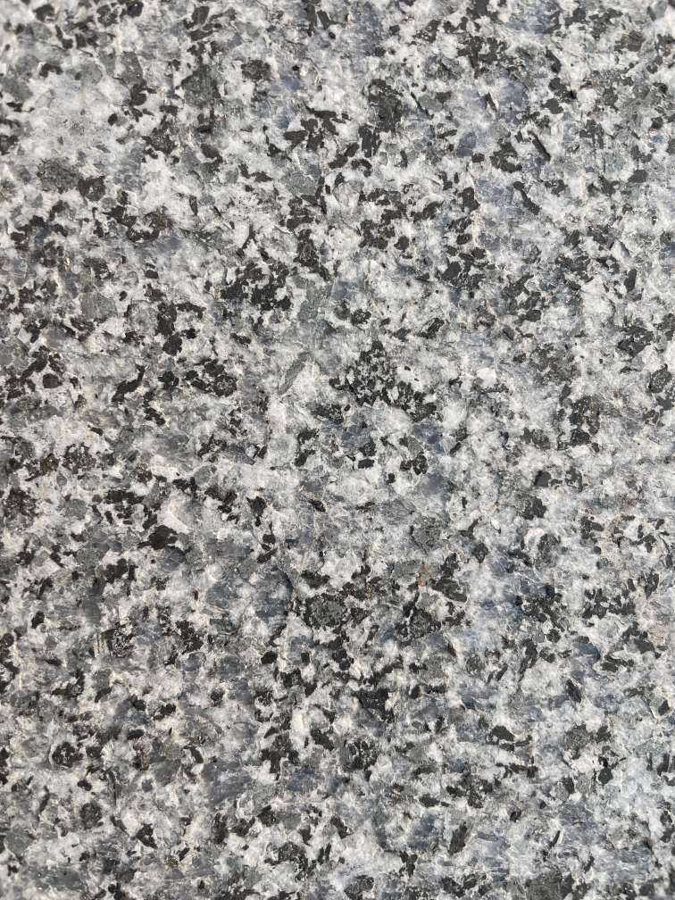Flamed Jiangxi Blue Crystal granite showing a lighter matte face with exposed crystal texture.