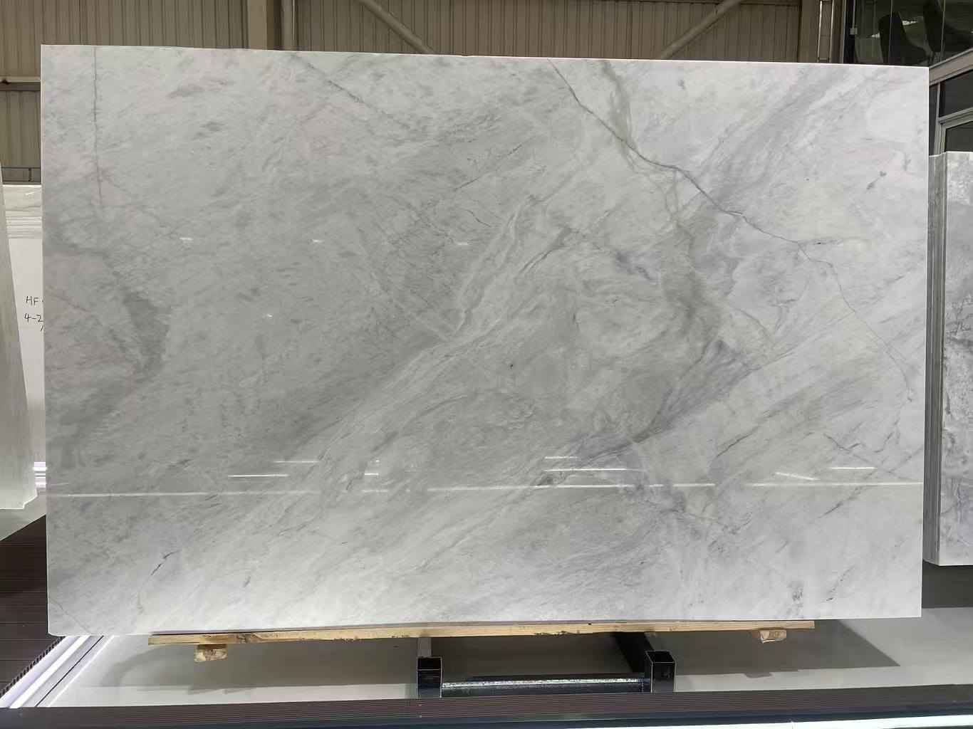 Chinese Fendi White Marble slab with a white background and light-grey veining