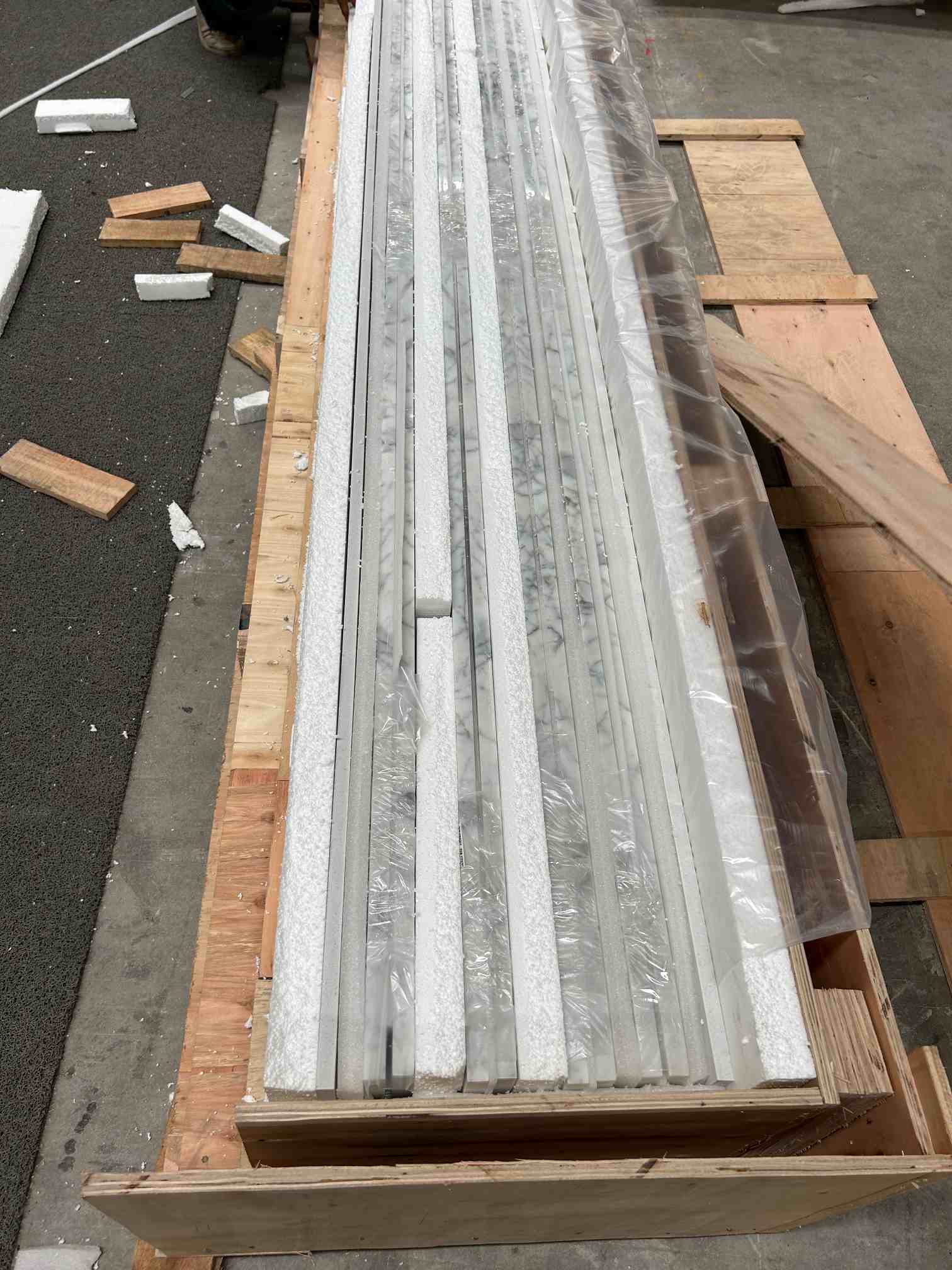 Calacatta White marble project pieces protected with foam inside a wooden crate