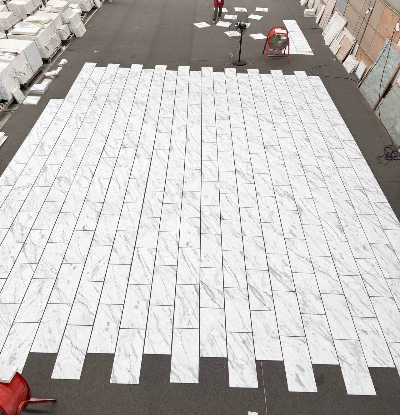 Vein-matched Calacatta White marble tiles arranged for continuous movement