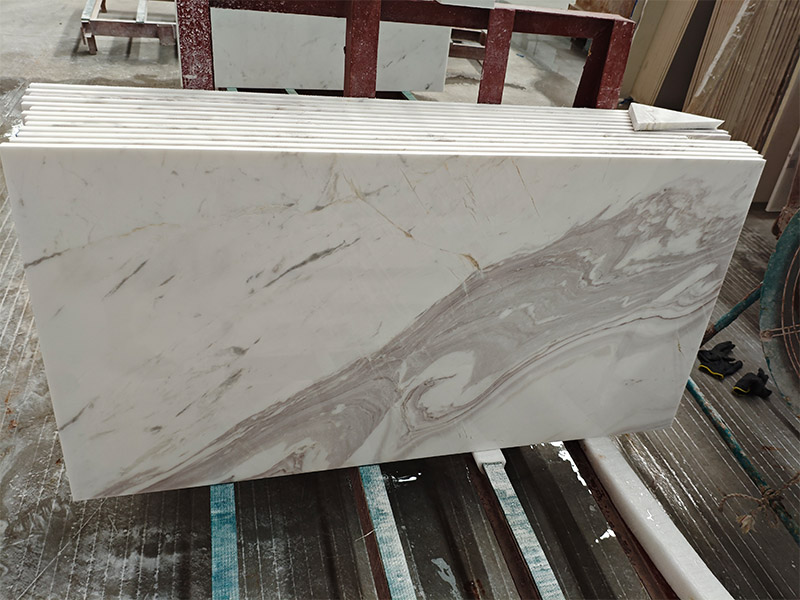 Polished Volakas marble tile with a strong grey feature vein on a white background