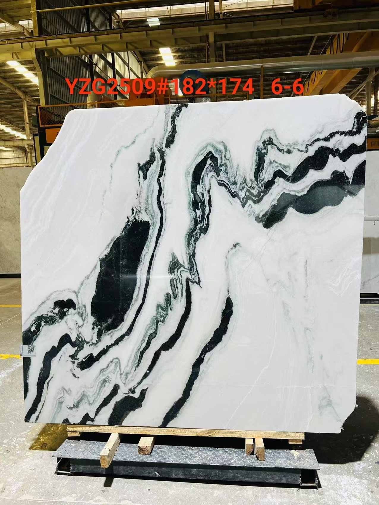 Natural Panda White Marble slab with curving black and grey veins and varied directional movement
