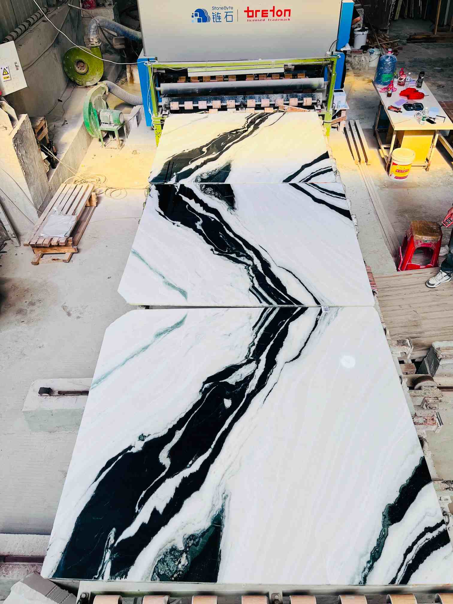 Bookmatched Panda White Marble slabs with mirrored flowing black veins on a white background