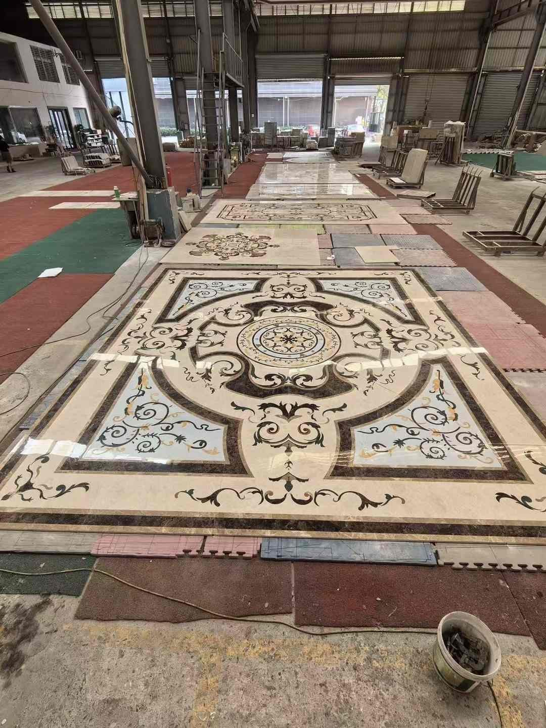 Excellent Stone factory dry-lay arrangement of large marble medallion and inlay floor panels