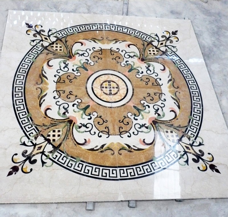 Multi-color waterjet marble medallion with warm stone colors and ornate border